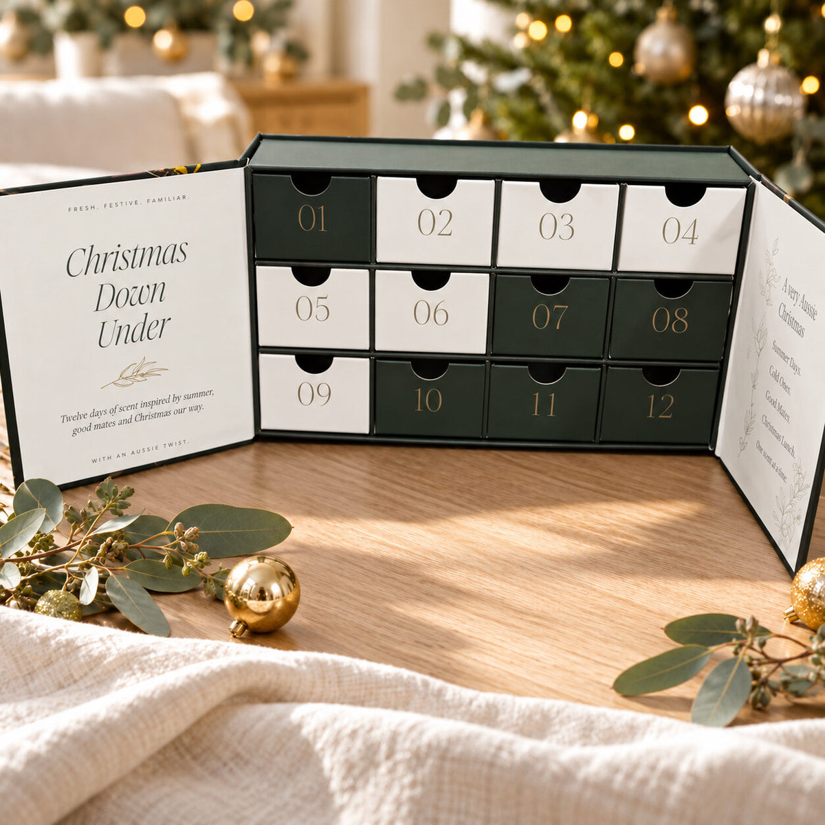 Advent calendar open, showing 12 numbered drawers